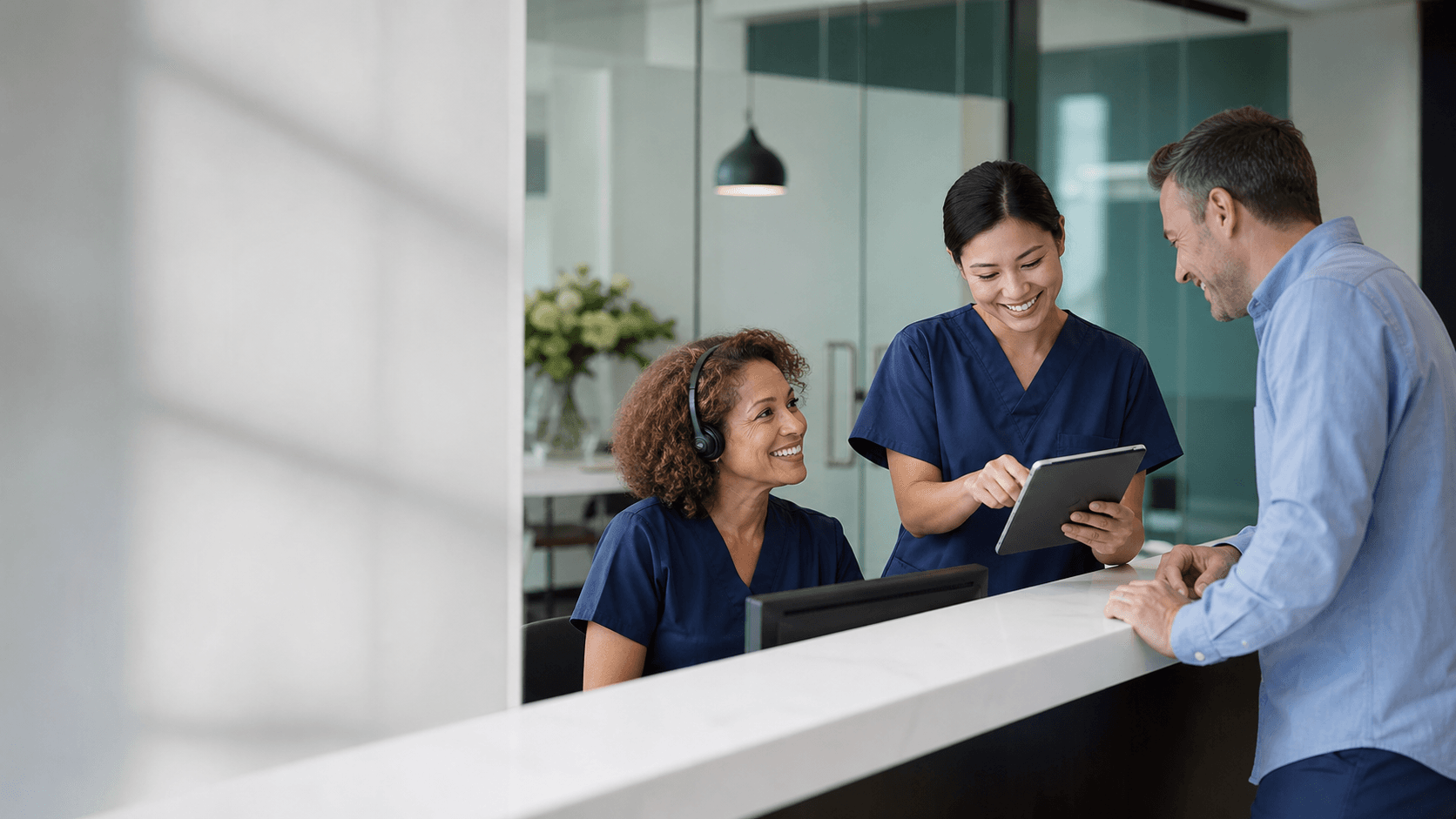 Practice team welcoming a patient at the front desk